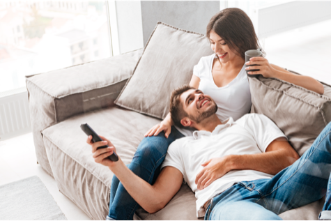 a man lying on girlfriends legs